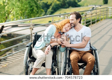 Similar – Daughter hugging senior mother in wheelchair