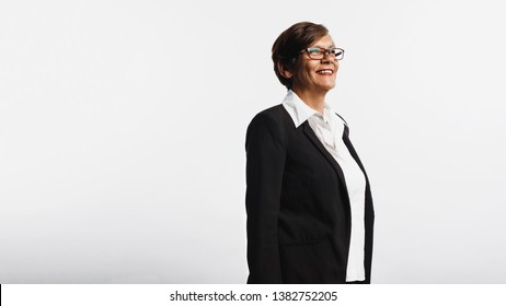 Cheerful Senior Woman Isolated On White Background Looking Away. Side View Of Smiling Senior Woman In Formal Business Attire.