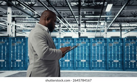 Cheerful server room engineer troubleshooting backend operations using software on tablet. Jolly data center programmer compiling software patches to fix bugs using device, camera A - Powered by Shutterstock - Get 15% off with code: PIKWIZARD15