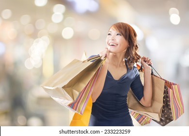 Cheerful Shopping Woman Of Asian Holding Bags.