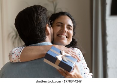 Cheerful Sincere Millennial Hispanic Woman Cuddling Husband, Feeling Thankful For Prepare Surprise Gift, Accepting Happy Birthday Greetings Or Celebrating Special Family Event Anniversary, Head Shot.