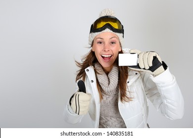 Cheerful Skier Woman Showing Ski Pass