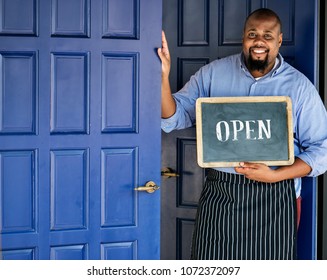 A Cheerful Small Business Owner With Open Sign