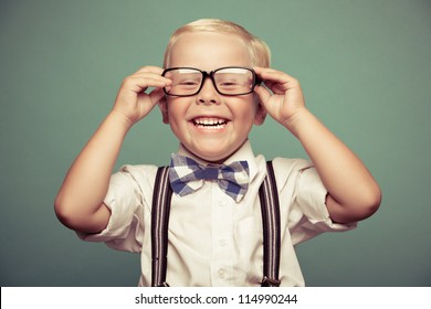 Cheerful Smiling Boy On A Green Background.