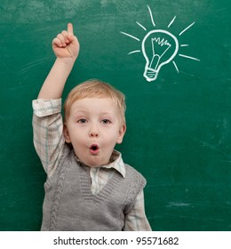 Cheerful Smiling Child At The Blackboard. School Concept