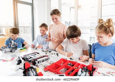 Cheerful Smiling Children Constructing Lego