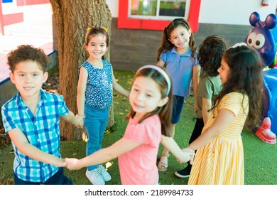 Cheerful Smiling Kids Holding Hands While Playing A Fun Game Together At Kindergarten Recess