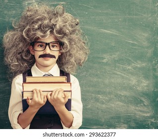 Cheerful Smiling Little Kid (boy) Against Chalkboard. Looking At Camera. Little Einstein Style. School Concept