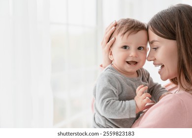 Cheerful smiling mother and little baby kid child. Family motherhood moments. Nanny childminder holding small toddler newborn baby infant with love and care. Adoption and IVF