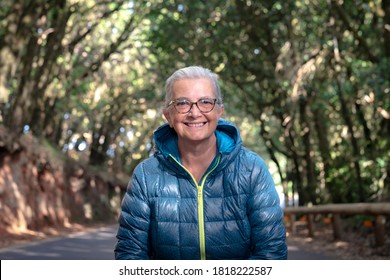 Cheerful Smiling Senior Woman With White Hair And Glasses Enjoying Freedom And Nature In Excursion In The Woods