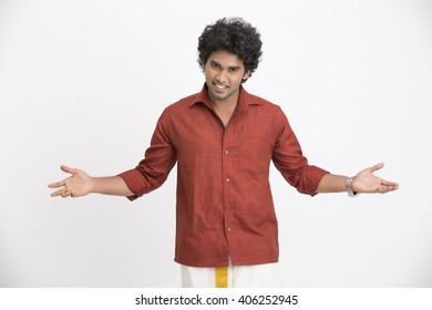 Cheerful South Indian man gesturing on white background. 