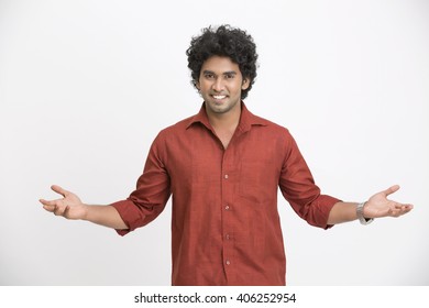 Cheerful South Indian man gesturing on white background. 