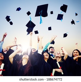 Cheerful Students Throwing Graduation Caps In The Air