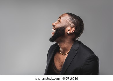 Cheerful successful young  African American man studio portrait in full suit 
