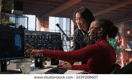 Cheerful supervisor in artificial intelligence startup enjoying laughter with worker coding applications. Happy team leader joking with employee doing code testing in relaxed workspace, camera A