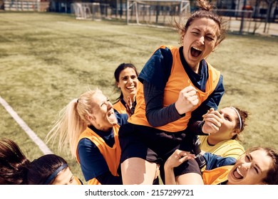 Cheerful team of female soccer players celebrating victory and carrying on of teammates who is shouting out of joy on stadium. - Shutterstock ID 2157299721