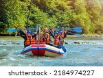 cheerful team is rafting on a mountain river