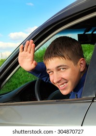 Cheerful Teenager Sit In The Car And Wave Goodbye