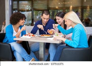 Cheerful Teenagers Having Lunch In Restaurant, Smiling And Talking