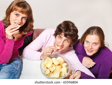 Cheerful Teens Eating Crisps