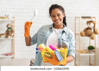 Cheerful Tidy African American Teen Girl Holding Cleaning Tools, Going To Clean Her Room, Empty Space