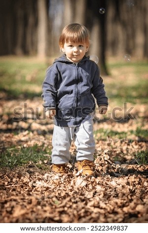 Similar – Image, Stock Photo Cute baby seeing falling leaves