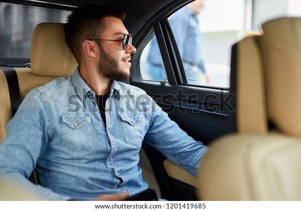 cheerful tourist is going sightseeing by car.\
close up side view photo. rest\
concept