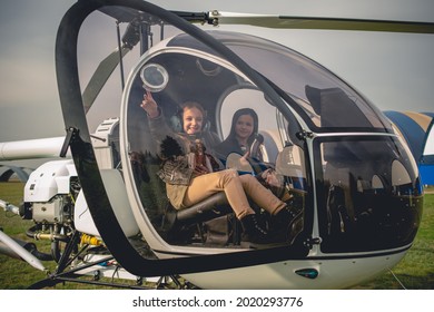 Cheerful Tween Girl Pointing To Sky From Helicopter Cockpit