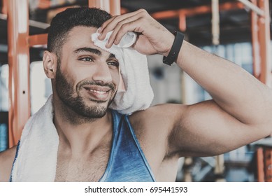 Cheerful unshaven man feeling fatigue after training - Powered by Shutterstock