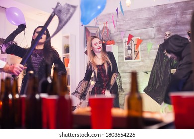 Cheerful Vampire Woman At A Halloween Party. Beer Caps