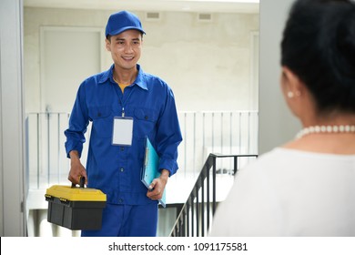 Cheerful Vietnamese Handyman Coming To Home Of Senior Woman To Repair Something