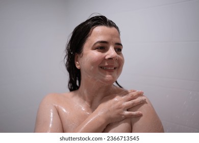 Cheerful woman bathing in bathroom with a happy smile and wet hair - Shutterstock ID 2366713545