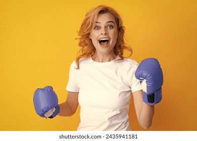 Cheerful woman celebrating victory. Woman in boxing gloves. Screaming strong young woman boxer. - Powered by Shutterstock