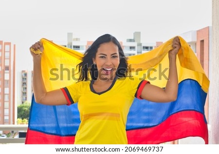 Cheerful woman with Colombian flag. Colombian soccer, Colombia national team, goal shout.