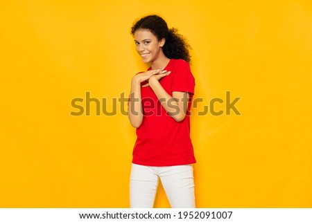 cheerful woman with curly hair red t-shirt casual wear yellow background