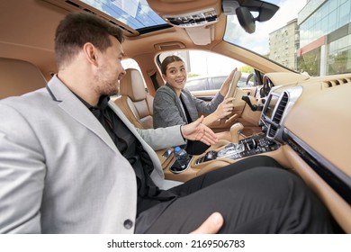 Cheerful Woman Driving Car With Man On Passenger Seat