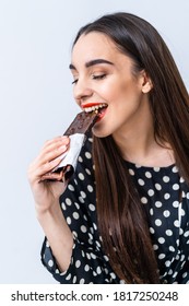 Cheerful Woman Eating Chocolate. Cropped Photo. Closeup. Black Chocolate With Nuts.