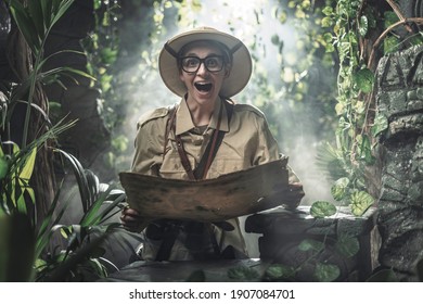 Cheerful woman exploring a tropical jungle with a map, she finds some ancient ruins