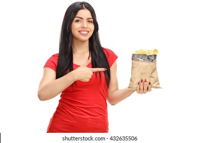 Cheerful Woman Holding A Bag Of Potato Chips And Pointing Towards It Isolated On White Background