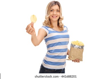 Cheerful Woman Holding A Bag Of Potato Chips In One Hand And A Single Chip In The Other Isolated On White Background