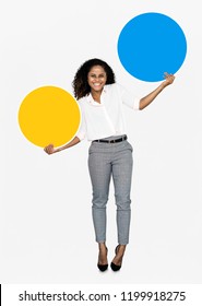 Cheerful woman holding colorful round boards