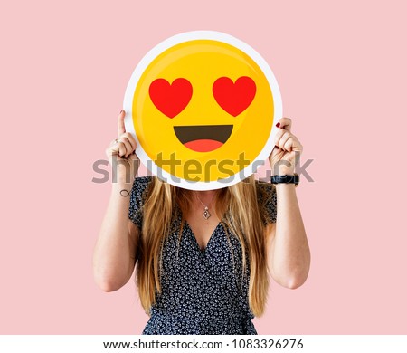 Cheerful woman holding emoticon icon