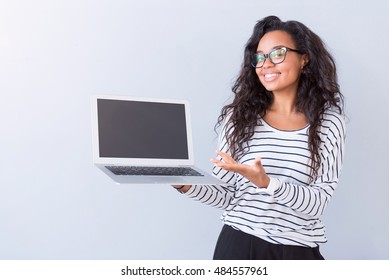 Cheerful Woman Holding Laptop