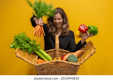 A cheerful woman holding a picnic basket brimming with fresh fruits and vegetables, radiating health and wellness. The vibrant yellow background enhances the lively, joyful atmosphere . Fun with food - Powered by Shutterstock