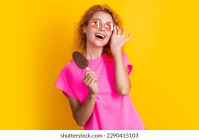 cheerful woman with icelolly ice cream isolated on yellow. woman with icelolly ice cream