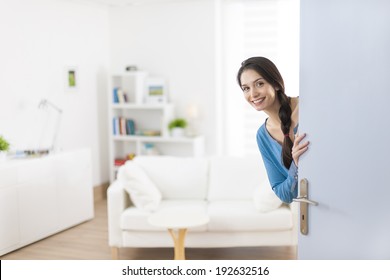 Cheerful Woman Inviting People To Enter In Home