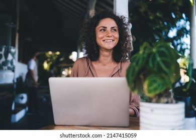 Cheerful woman with laptop computer laughing during time for online networking, happy Caucaisan IT professional with digital netbook technology enjoying digital nomad lifestyle during weekend - Powered by Shutterstock