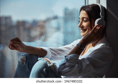 Cheerful Woman Listening To Music At Home