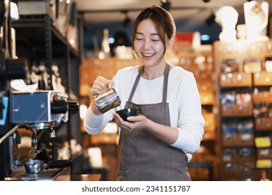 Cheerful woman making a coffee cup in cafe,Barista holding a cup of hot coffee for the first Morning. - Powered by Shutterstock