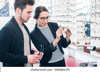 Cheerful Woman And Man Buying Glasses In Optician Shop